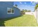 Fenced backyard features a well-maintained lawn and screened in outdoor living area with a pool at 11852 Lake Lucaya Dr, Riverview, FL 33579
