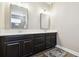 Bright bathroom with dual vanities, dark wood cabinets, neutral walls and tile floors at 11852 Lake Lucaya Dr, Riverview, FL 33579