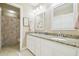 Stylish bathroom with double sinks, granite countertops, and modern lighting fixtures at 11852 Lake Lucaya Dr, Riverview, FL 33579