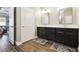 Neutral bathroom featuring dual sinks, dark wood cabinets, neutral walls and tile floors at 11852 Lake Lucaya Dr, Riverview, FL 33579