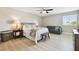 Cozy bedroom with neutral walls, a ceiling fan, and a comfortable seating area at 11852 Lake Lucaya Dr, Riverview, FL 33579