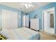 Bright blue bedroom features a ceiling fan, closet and a large white dresser at 11852 Lake Lucaya Dr, Riverview, FL 33579