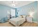 Bright and cheerful light blue bedroom with natural light and a cozy beanbag chair at 11852 Lake Lucaya Dr, Riverview, FL 33579