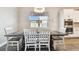 Cozy dining room features a wooden table, white chairs, and a window with natural light at 11852 Lake Lucaya Dr, Riverview, FL 33579