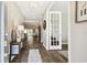 Inviting entryway featuring wood-look tile floors, decor, and a view through to the bright and open living spaces at 11852 Lake Lucaya Dr, Riverview, FL 33579