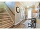 Welcoming entryway featuring a staircase, wood-look tile floors, and charming decor elements for a cozy atmosphere at 11852 Lake Lucaya Dr, Riverview, FL 33579