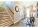 Inviting foyer with wood-look tile floors, a chandelier, and staircase leading to the second floor at 11852 Lake Lucaya Dr, Riverview, FL 33579