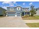 Charming two-story home with a three-car garage and mature landscaping at 11852 Lake Lucaya Dr, Riverview, FL 33579