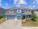 Stunning two-story home with a three-car garage and beautifully landscaped front yard at 11852 Lake Lucaya Dr, Riverview, FL 33579