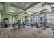 Community gym with a variety of exercise equipment, ceiling fans, and large windows at 11852 Lake Lucaya Dr, Riverview, FL 33579