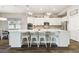 Bright, spacious kitchen featuring white cabinets, a large island, pendant lights, and stainless appliances at 11852 Lake Lucaya Dr, Riverview, FL 33579