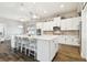 Bright, open kitchen with a large island, white cabinetry, and stainless steel appliances at 11852 Lake Lucaya Dr, Riverview, FL 33579