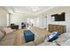 Comfortable living room with a tray ceiling, a view into the loft, and modern furnishings at 11852 Lake Lucaya Dr, Riverview, FL 33579