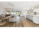 Open concept living room flowing into a kitchen area with modern decor and lots of natural light at 11852 Lake Lucaya Dr, Riverview, FL 33579