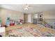 Bright loft featuring a colorful rug and a view of the stairs leading to the first floor at 11852 Lake Lucaya Dr, Riverview, FL 33579