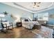 Serene main bedroom with tray ceilings and cozy seating area at 11852 Lake Lucaya Dr, Riverview, FL 33579