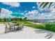 Outdoor patio with seating and umbrella offers a serene view of the lake, perfect for entertaining or relaxing at 11852 Lake Lucaya Dr, Riverview, FL 33579