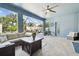 Outdoor patio with tile floors, ceiling fan, and comfortable seating with views of fenced yard at 11852 Lake Lucaya Dr, Riverview, FL 33579
