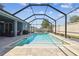 Relaxing screened-in pool area with brick pavers and a view of the backyard at 11852 Lake Lucaya Dr, Riverview, FL 33579
