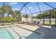 Covered pool with brick paver deck, lounge chairs and landscaping, perfect for outdoor entertaining at 11852 Lake Lucaya Dr, Riverview, FL 33579