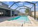 Covered pool with brick paver deck and screened in outdoor living space at 11852 Lake Lucaya Dr, Riverview, FL 33579