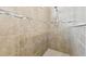 Close up of a neutral tiled shower with shower head and built in soap dish and accent tile at 11852 Lake Lucaya Dr, Riverview, FL 33579