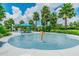 Community splash pad with various water features and shaded seating area surrounded by tropical landscaping at 11852 Lake Lucaya Dr, Riverview, FL 33579