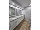 Bright bathroom with granite countertops, double sinks and updated lighting at 12312 Golden Oak Cir, Hudson, FL 34669