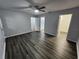 A spacious bedroom with modern vinyl flooring, ceiling fan, and multiple entryways at 12312 Golden Oak Cir, Hudson, FL 34669