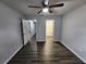 Bedroom with luxury vinyl floors, a ceiling fan, and access to adjoining rooms at 12312 Golden Oak Cir, Hudson, FL 34669