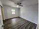 Bedroom features luxury vinyl floors, a ceiling fan, and a window at 12312 Golden Oak Cir, Hudson, FL 34669