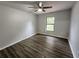 Bedroom with vinyl flooring, neutral walls, a window, and a ceiling fan at 12312 Golden Oak Cir, Hudson, FL 34669
