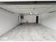 Spacious garage with white concrete walls, overhead lighting and ample room for storage and vehicles at 12312 Golden Oak Cir, Hudson, FL 34669