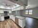 Open kitchen features granite counters, stainless appliances, and seamless access to living area at 12312 Golden Oak Cir, Hudson, FL 34669