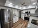 Updated kitchen showcasing stainless steel appliances, white cabinets, and stylish countertop at 12312 Golden Oak Cir, Hudson, FL 34669