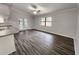 Bright, open living area featuring wood floors and an adjacent kitchen space at 12312 Golden Oak Cir, Hudson, FL 34669