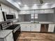 Bright kitchen featuring stainless steel appliances, granite countertops, and modern fixtures at 12312 Golden Oak Cir, Hudson, FL 34669