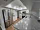 Modern kitchen featuring stainless steel appliances, granite countertops, and wood flooring at 12312 Golden Oak Cir, Hudson, FL 34669
