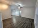 Spacious living room featuring wood flooring, ceiling fan, and neutral colors at 12312 Golden Oak Cir, Hudson, FL 34669