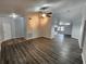 Inviting living room with wood flooring, ceiling fan, and views into kitchen at 12312 Golden Oak Cir, Hudson, FL 34669