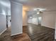 Open-concept living area boasts modern wood flooring, neutral paint, and ample natural light at 12312 Golden Oak Cir, Hudson, FL 34669