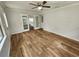 Open layout features wood-look flooring and french doors to kitchen at 12312 Golden Oak Cir, Hudson, FL 34669