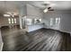 Open layout features wood-look flooring, integrated kitchen access, and bright, neutral finishes at 12312 Golden Oak Cir, Hudson, FL 34669