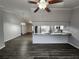 Spacious open-concept living area with luxury vinyl plank flooring and kitchen view at 12312 Golden Oak Cir, Hudson, FL 34669