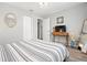 Comfortable bedroom with a decorative mirror and a television on a quaint desk at 1276 Bertland Way, Clearwater, FL 33755