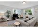 Bright living room with modern decor, comfortable seating, large windows, and stylish accents, perfect for relaxation at 1276 Bertland Way, Clearwater, FL 33755