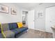 Comfortable living room space featuring a blue futon and stylish decor at 1276 Bertland Way, Clearwater, FL 33755