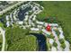 Aerial view showing the home's location within the community with lakes and green spaces at 1309 Pine Ridge E Cir # D3, Tarpon Springs, FL 34688