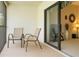 Relaxing balcony with outdoor seating, offering a private outdoor space with sliding door at 1309 Pine Ridge E Cir # D3, Tarpon Springs, FL 34688