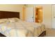Bedroom showcasing a queen bed with yellow patterned bedding, with access to a bathroom and closet at 1309 Pine Ridge E Cir # D3, Tarpon Springs, FL 34688